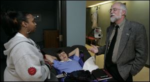 John Martin, head of the state s developmental disabilities agency, visits therapist Lakisha Warr, left, and resident Stephanie Pollack at the Northwest Ohio Developmental Center.