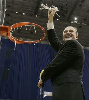 Ohio State coach Thad Matta finishes taking down a net after the Buckeyes beat Memphis to win the South Regional.