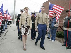 REG marine31p  03/31/07 The Blade/Dave Caption: Lance Corporal Evan E. Miller and his girlfriend Jennifer Constien, left, walk down a sidewalk lined by members of the Legion Riders, as he arrives  at a party in his honor at the VFW in downtown Defiance on Saturday, March 31, 2007.  Summary: Defiance Mayor Bob Armstrong is declaring March 31 to be Lance Corporal Evan E. Miller Day in Defiance. Evan, who is a Marine reservist, was seriously injured in Iraq.