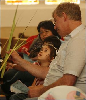 Slug: CTY Palms31p  Date:  03/31/2007   Location:  Toledo, OH  Caption: THE BLADE/ERIC SUMBERG  Destiny Ball, 3, looks at her palm with her grandfather Brad Ball at the Palm Sunday service at St. Lucas Evangelical Lutheran Church in America on Saturday.   Sunday is Palm Sunday, the start of the Holy Week that leads into Easter Sunday, a day in which Christians remember Jesus' triumphant entry into Jerusalem with the people waving palms.         Summary:  Palm Sunday service at St. Lucas Evangelical Lutheran Church in America led by Pastor Martin E. Billmeier.
