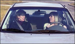Haley Lancaster, 16, gets behind the wheel for some driving time with her mother, Sue Lancaster.