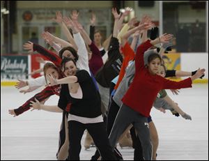 Ellie Messinger, left, and Annie Neumann, right, lead their respective groups of skaters in a run-through of their chorus-line routine at the BGSU Ice Arena for the Ice Horizons 2007 show.