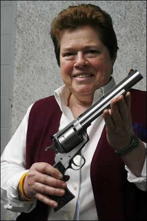 Theresa Cleland of Cleland's Outdoor World, with a .44 Magnum, has refused to sell to questionable customers.