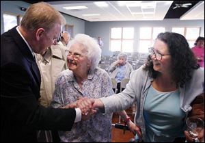 Gov. Ted Strickland greets Elizabeth Smith and her daughter-in-law, Toni Smith, at the Mayores Senior Center, where he talked about his proposed tax cut for seniors yesterday.