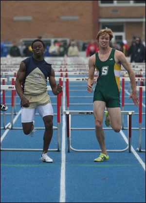 DaJon Booth of St. John s, left, and Paul Szeltner of Strongsville, push for the finish line in the 110-meter hurdles at the St. Francis Knight Relays. Booth took fi rst place.