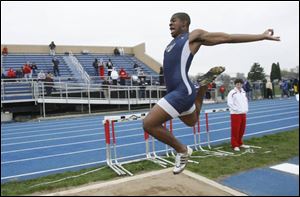 Kevin Koger of Whitmer long jumps 20 feet, 6 3/4 inches as he and teammate Jeremy Jones won the event at the Knight Relays.