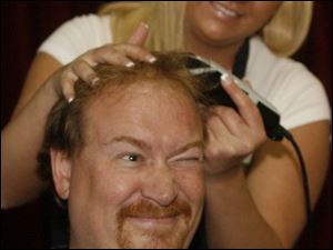Slug: CTY Shave05p        Date:  05/04/2007 Caption:  THE BLADE/ERIC SUMBERG   Principal Bill Buzzell of Glenwood Elementary squints and squirms as DeAnn Patronik of Fiesta Salon & Tanning in Perrysburg takes the first cut of his hair.   Summary:  As an incentive for students to do well on their state  proficiency tests, Glenwood Elementary School Principal Bill Buzzell promised to shave his head if they met a 90 percent rate on a checklist that teachers had which ensured that students completed the tests using the proper techniques.  Mr. Buzzell and four other male teachers had their heads shaved and two female teachers had their hair dyed by students.