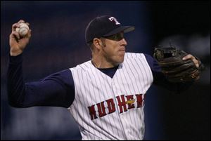 Mud Hens third baseman Mike Hessman throws out the Yankees  Kevin Thompson in the seventh inning.
