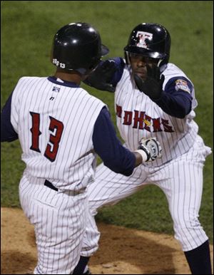Timo Perez signals to
Ramon Santiago that he can score standing up on Brent Clevlen's two-run double in the seventh inning last night in a victory over Scranton/Wilkes-Barre.