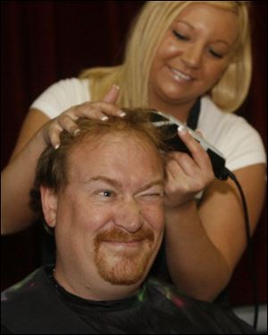 Slug: CTY Shave05p        Date:  05/04/2007 Caption:  THE BLADE/ERIC SUMBERG   Principal Bill Buzzell of Glenwood Elementary squints and squirms as DeAnn Patronik of Fiesta Salon & Tanning in Perrysburg takes the first cut of his hair.   Summary:  As an incentive for students to do well on their state  proficiency tests, Glenwood Elementary School Principal Bill Buzzell promised to shave his head if they met a 90 percent rate on a checklist that teachers had which ensured that students completed the tests using the proper techniques.  Mr. Buzzell and four other male teachers had their heads shaved and two female teachers had their hair dyed by students.