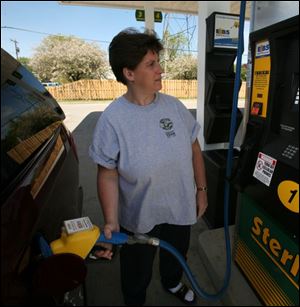 Brenda McDonald pumps E85 at the Sterling store on Secor Road north of Alexis Road.