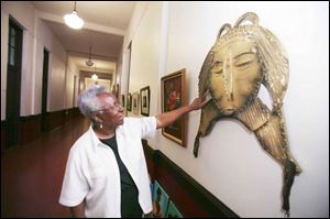 Alice Grace used a jig saw to help make the huge mask that hangs outside her studio at the
Collingwood Arts Center.

