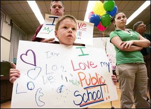 Tyler Wiley, 14, and his brother Steward, 5, both students in Toledo schools, help out.
