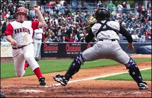 Louisville catcher Ryan Jorgensen is still waiting for the throw, but he was able to make the catch and tag Chris Shelton.