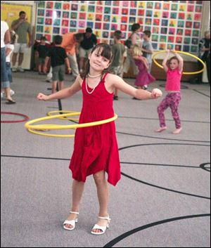Breanna Schaadt, 9, works with her hula hoop.