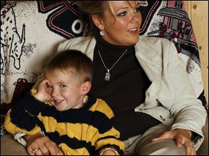 Danielle Dressel, with her son, Noah, has attended dozens of functions since the night her husband was killed on duty.