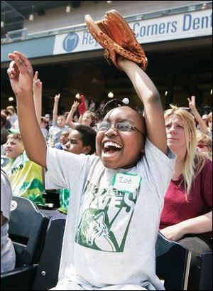 With fan support like this, how can the Toledo Mud Hens
ever lose? An exuberant Zoe Rayford, 10, from Whittier
School was in the crowd that saw the Hens defeat Charlotte, 6-5, yesterday. 