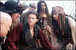 Martin Klebba, left, Geoffrey Rush, Orlando Bloom, and Naomie Harris in Pirates Of The Caribbean: At World s End.