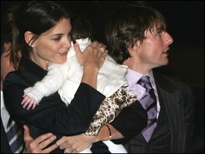 Tom Cruise, right, and actress Katie Holmes, believed to be holding their daughter Suri, arrive at Rome's town hall, in this file photo from Nov. 15, 2006. 