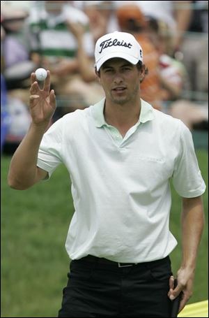 Adam Scott acknowledges the crowd after shooting a 62 yesterday at Muirfield Village.