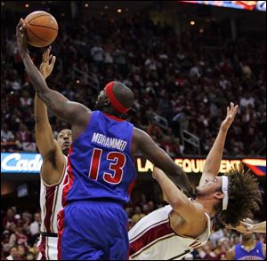 Detroit's Nazr Mohammed knocks down Cleveland's Anderson Varejao while being guarded by Donyell Marshall.