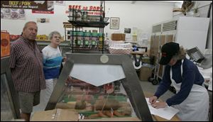 Sophia Herman, right, fills an order for customers at Kilgus Meats, which offers a range of German food specialties. 