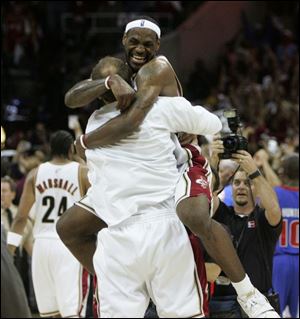LeBron James celebrates with Zydrunas Ilgauskas after the Cavaliers topped the Pistons to clinch the Eastern Conference title.