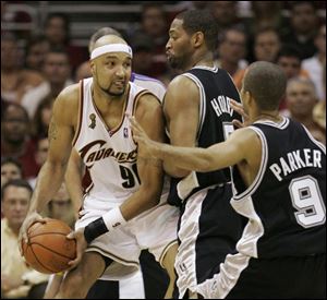 The Spurs' Robert Horry and Tony Parker double-team the Cavaliers' Drew Gooden, who had 13 points and 12 rebounds.