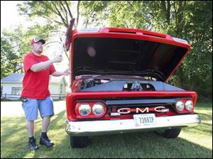 Steve Barrand of Toledo proudly shows his 1965 GMC pickup truck.