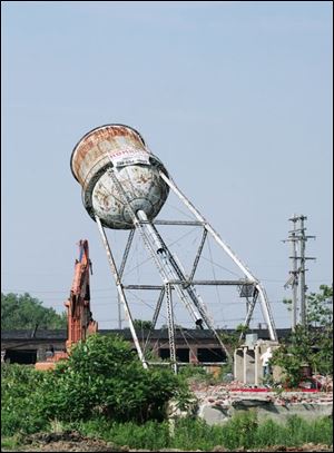  The water tower of the former Jefferson Smurfit Paper Plant is taken down as land is cleared for the new park site.
