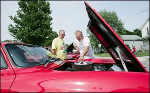 Donald Oates, from left, and Larry Rinehammer, both of Findlay, check out a 1963 Corvette Grand Sport owned by Mike Young of Gibsonburg. 
