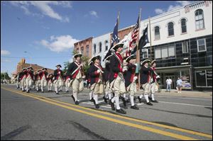 Sounds of America's glorious past ring out as the Plymouth, MI Fife and Drum Corps strides down South Monroe St.