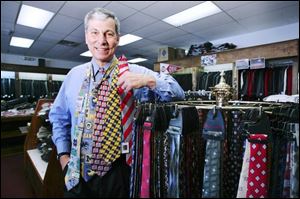 Fewer fathers will receive such traditional items as these neckties shown by retailer Jim Damschroder.
