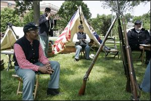 Members of the 5th United States Colored Troops Company C, Lee Randles, left, Rod Roberts, Jim Proctor, and Mike Esslinger, are encamped across from the Toledo Museum of Art.