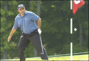 Angel Cabrera tries to apply a bit of body English on a chip shot out of the rough on No. 6.
