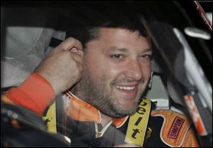 Tony Stewart waits to practice at Michigan International
Speedway for today s Citizens Bank 400.