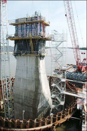 The Skyway s pylon, which eventually would reach 400 feet, begins to take shape in the cofferdam constructed in the river. 