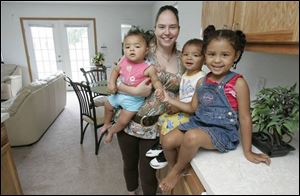 Aimee Przybysz and children Jayla Shuman, 1, left, Jamall Shuman, 2, and Jazmine Shuman, 4, in a new four-bedroom home.