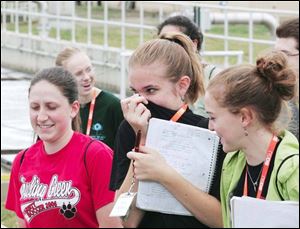 From left, Rebecca Szparagowski of Bowling Green and Jen Kaltenbach and Melissa Leimgruber of North Baltimore react to odors from the sewage treatment plant.