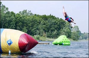 Molly Swan of Belfast expects to make a splash in Stony Lake as she soars through the air.