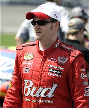 NASCAR driver Dale Earnhardt Jr., walks down pit row before the qualifying laps for Sunday's Citizens Bank 400 auto race at Michigan International Speedway in Brooklyn, Mich., Friday, June 15, 2007.