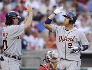 Carlos Guillen, right, celebrates his two-run homer with Magglio Ordonez. Both have eight-game hitting streaks.