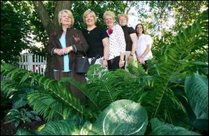 Maumee Garden Club members, from left, Darlene Carpenter, Connie Barron-Smith - whose garden is pictured - Marcia McCready, Susan Utterback, and Sara Becker celebrate the group's 75th anniversary.