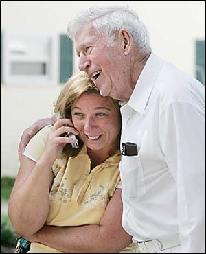 Kerry Katafiasz shows a relieved smile as she explains to someone on the phone how Cecil McCourt, who lives on nearby Breezeway Dr., alerted her sleeping daughter Brittany, 17, of the fire.