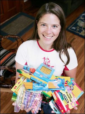 Lisa Kuhl of Waterville, who teaches science at Springfield Middle School, displays some of the supplies she collected from her students to donate to La Democracia School in Belize.