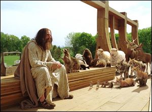 Evan Baxter (Steve Carell) takes a break from building his ark, as a group of potential passengers watches his every move in the Universal Studios film Evan Almighty.