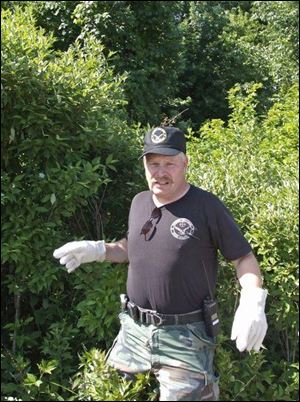 Volunteer searcher Greg Kenepp of Cuyahoga Falls, Ohio, makes his way into a clearing while looking for clues.