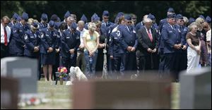 Mourners bow their heads at the funeral for Lt. Col. Kevin Sonnenberg in Hockman Cemetery outside McClure, Ohio. 