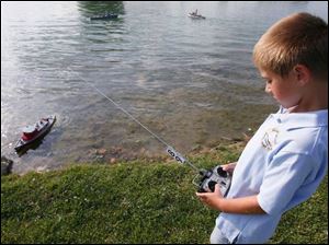 Ben Bostater, 7, concentrates on steering his boat.  