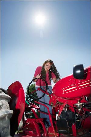 Jessica Demlow of Clayton, Mich., polishes her 1948 Cockshutt 30 tractor.
